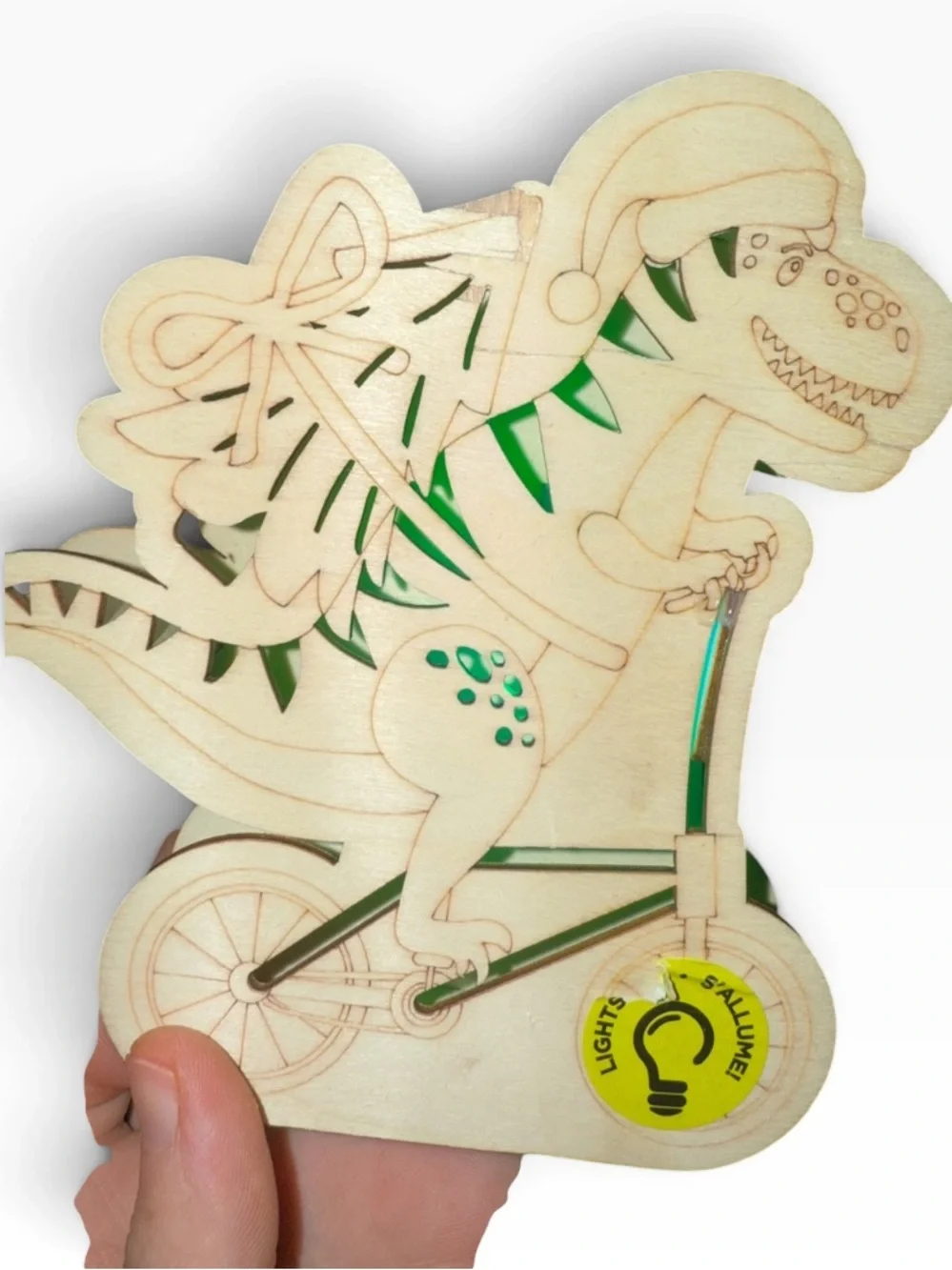 Cut out wood Dino on bike carrying a Christmas tree,